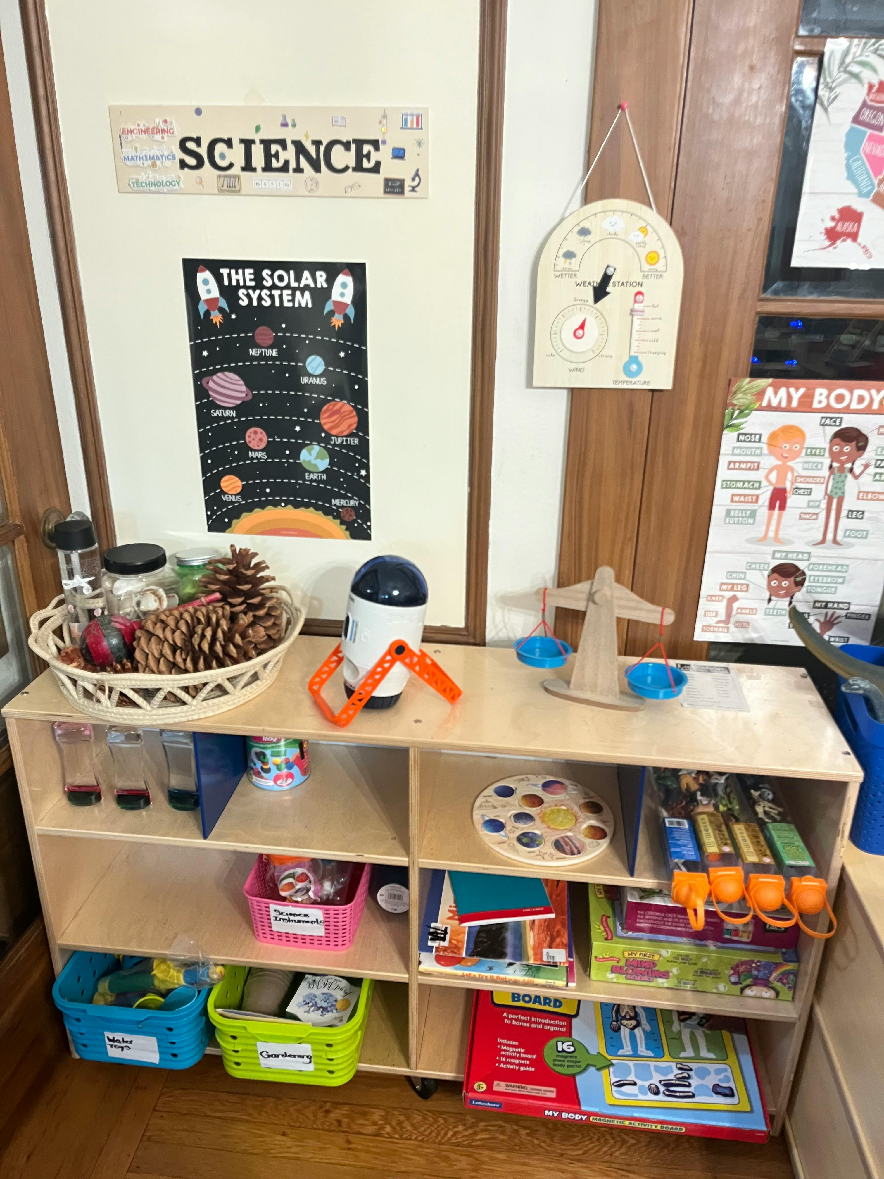 Science-themed classroom shelf with educational materials