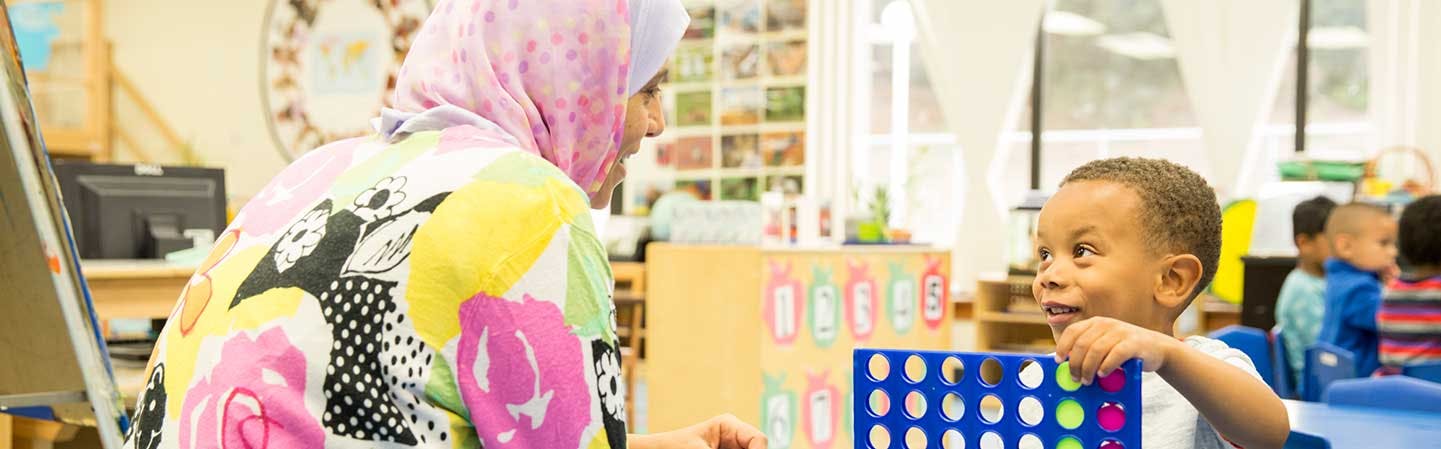 Person and child playing a board game