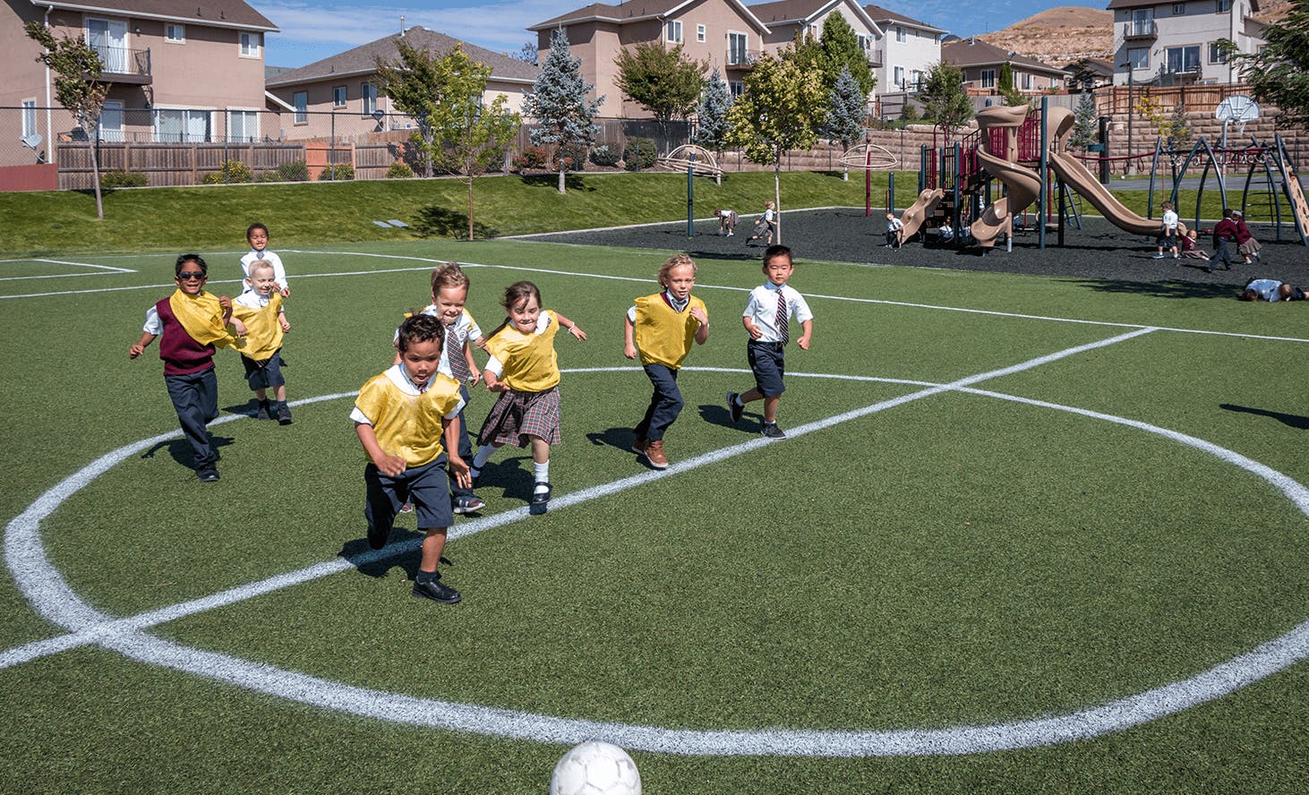 Children running on a soccer field