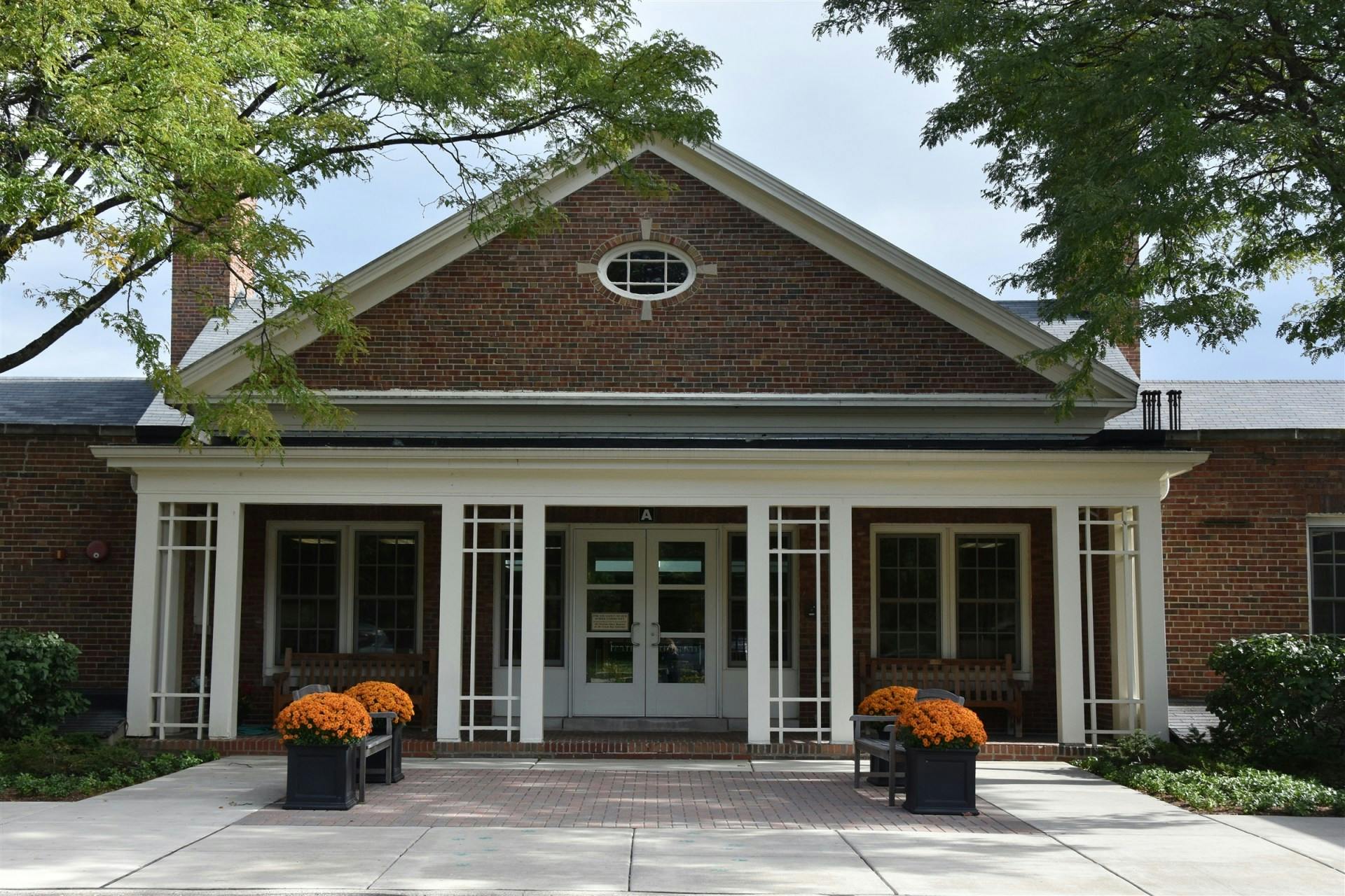 Brick building with a white portico and double doors