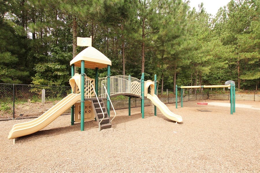 Playground with slides, stairs, and swings