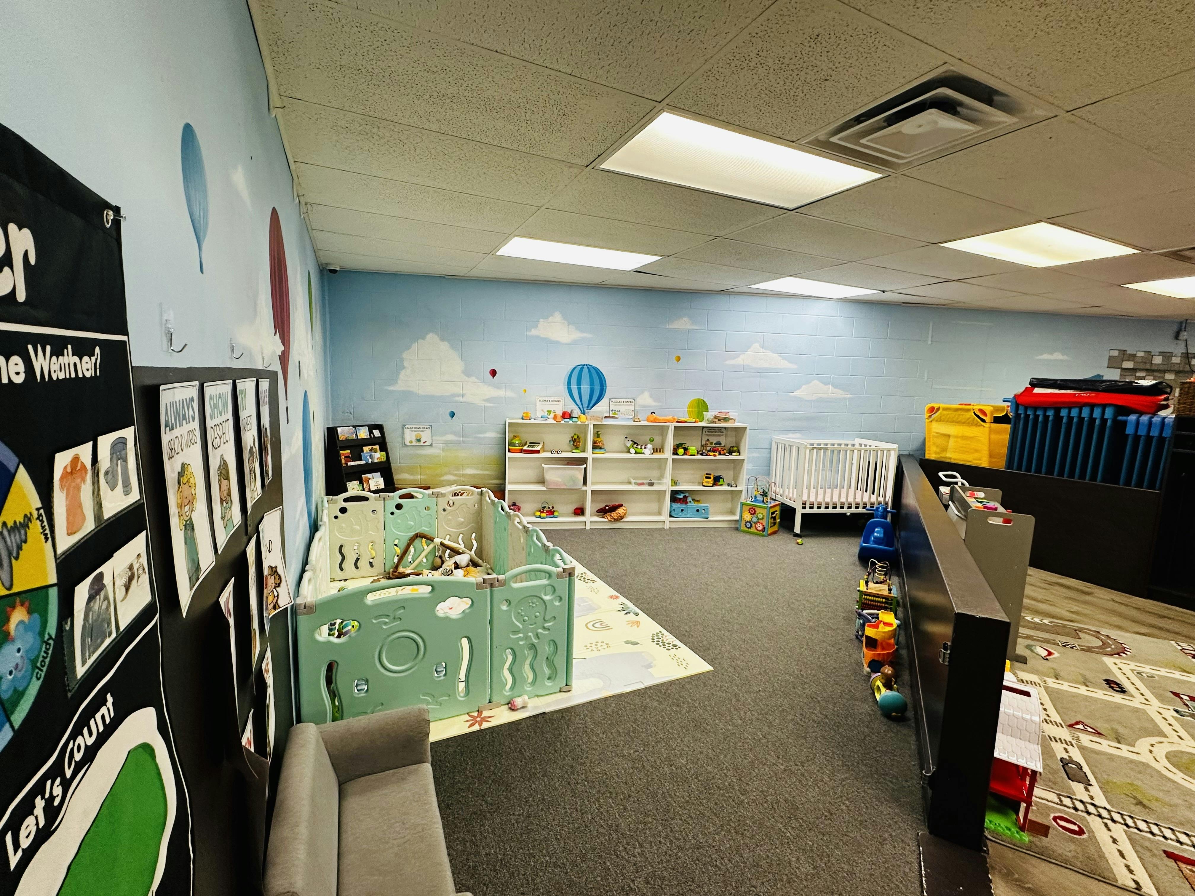 Playroom with a playpen, crib, and shelves of toys