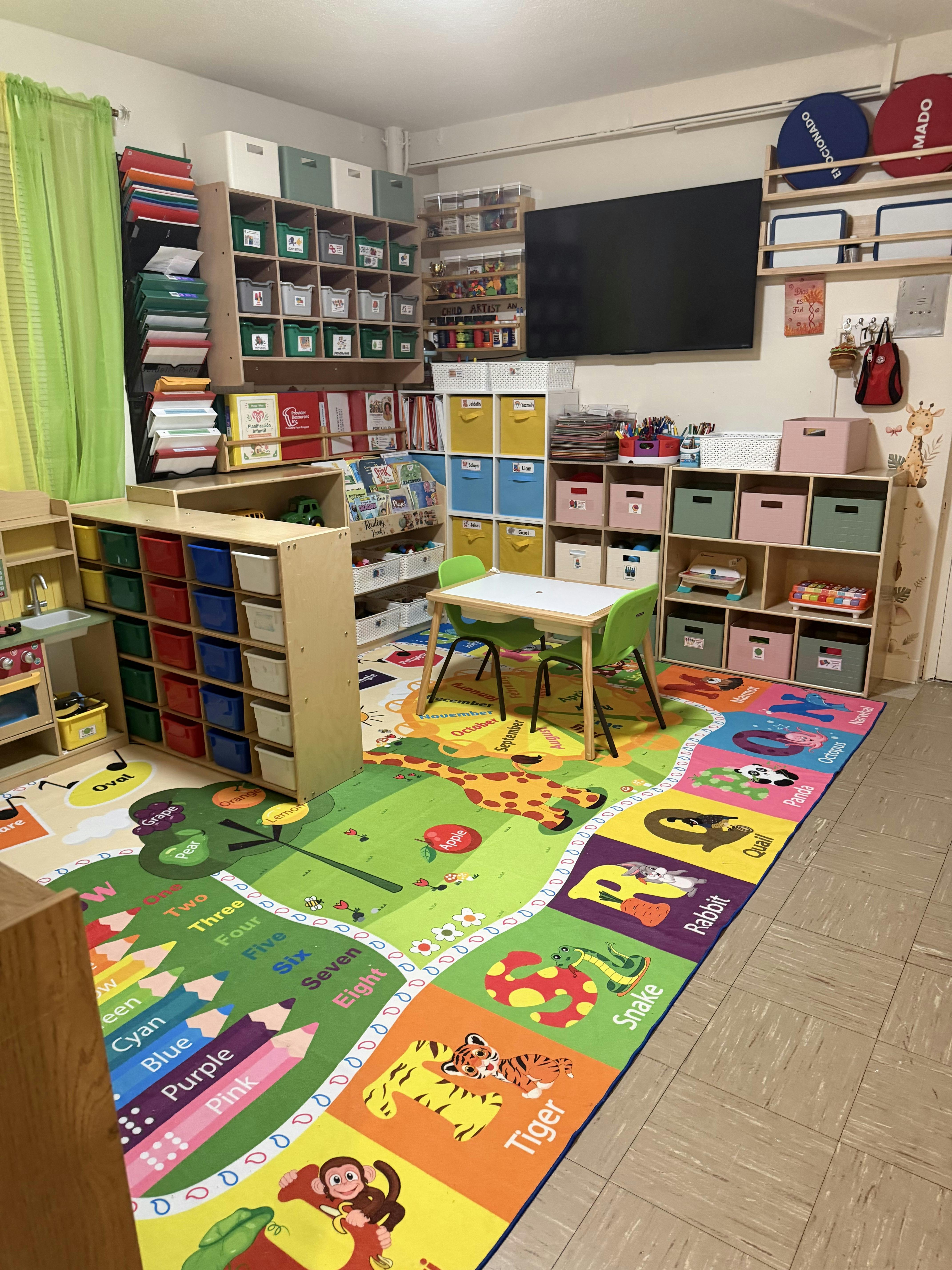 Childcare classroom with storage cubbies and an educational floor mat