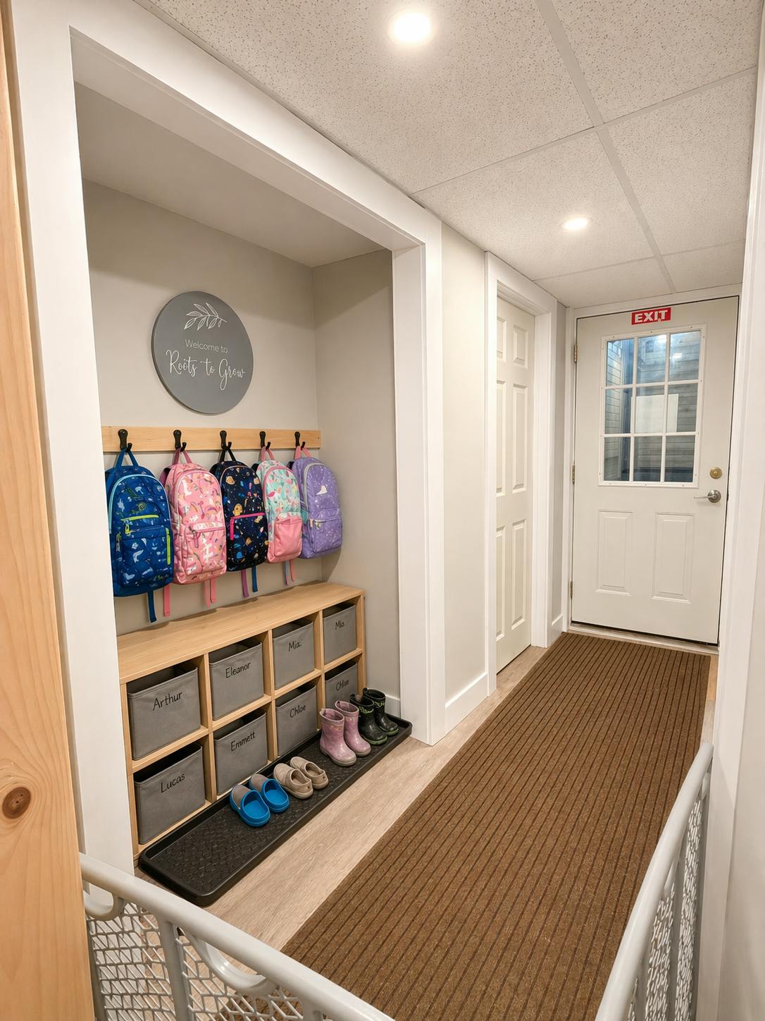 Colorful child-sized backpacks hanging above labeled cubbies with shoes