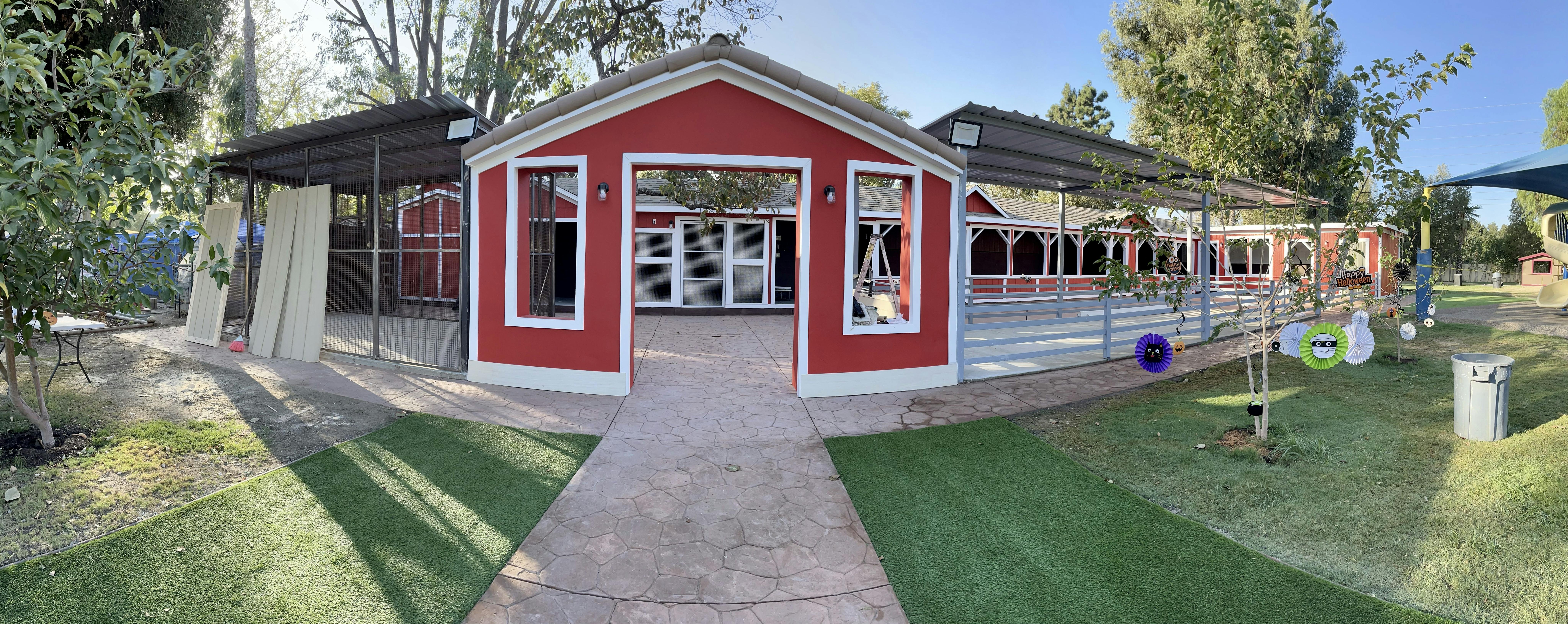 Red building with white trim and a covered walkway