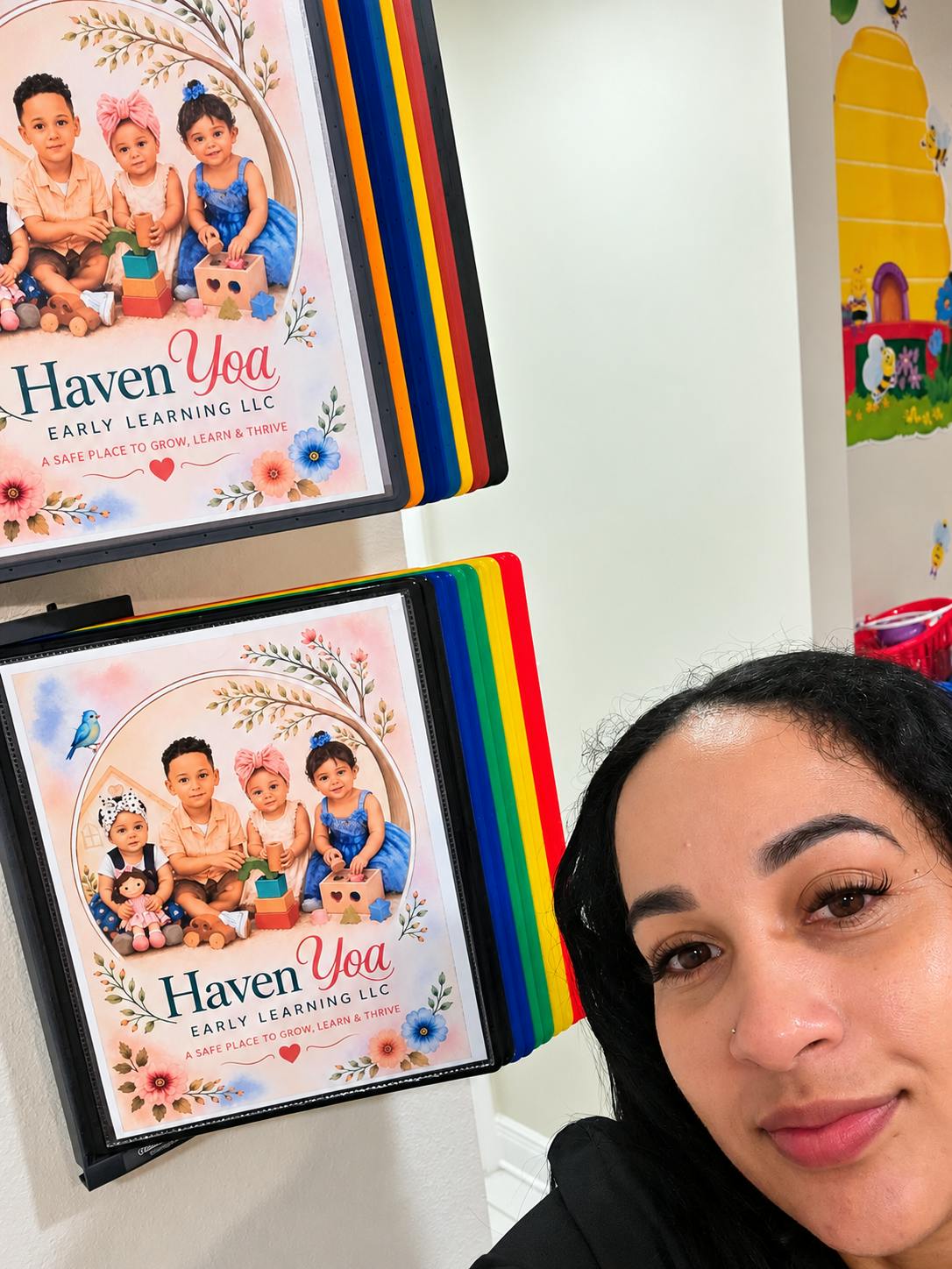 Person standing next to posters featuring children playing