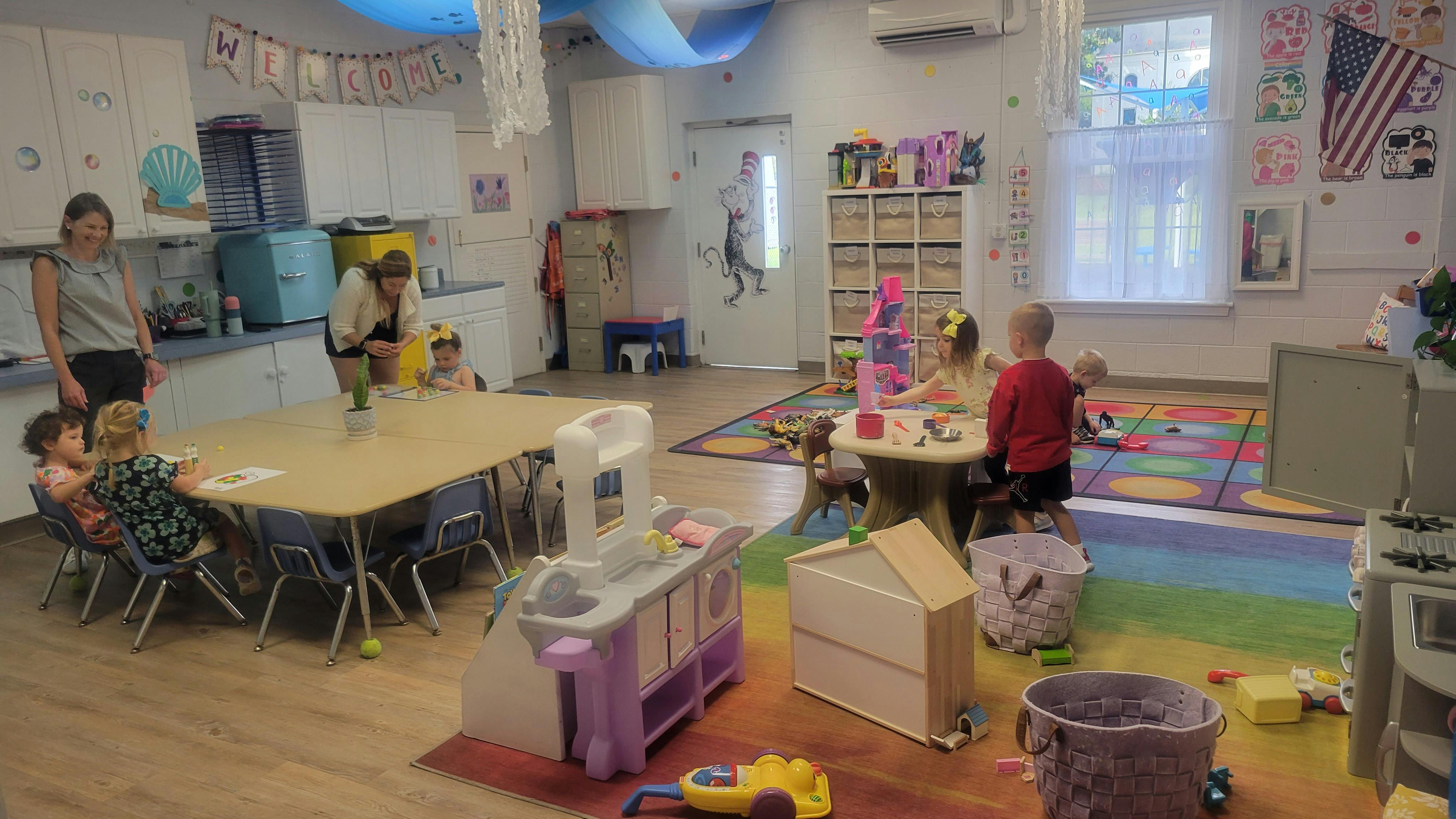 Adults and children in a classroom