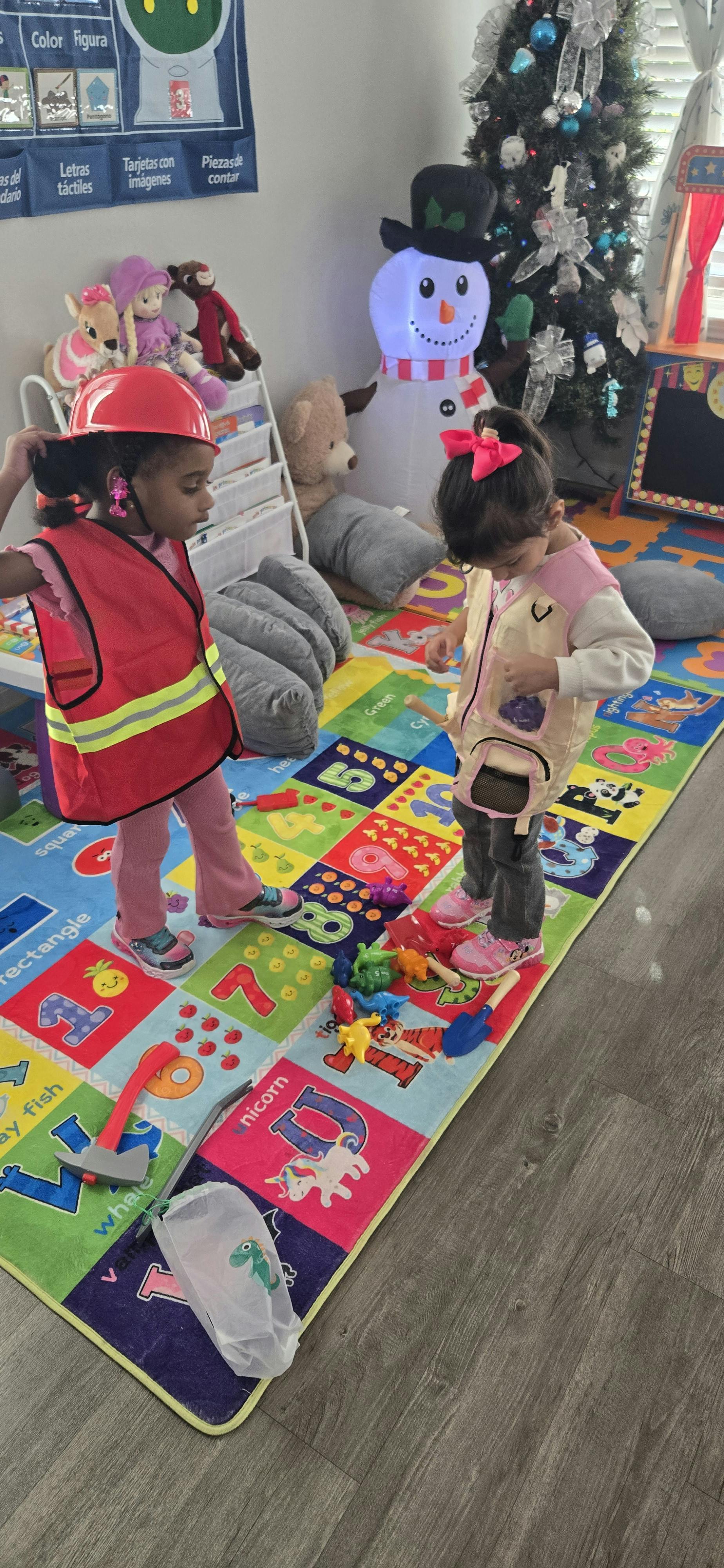 Two children playing on a colorful rug with toys