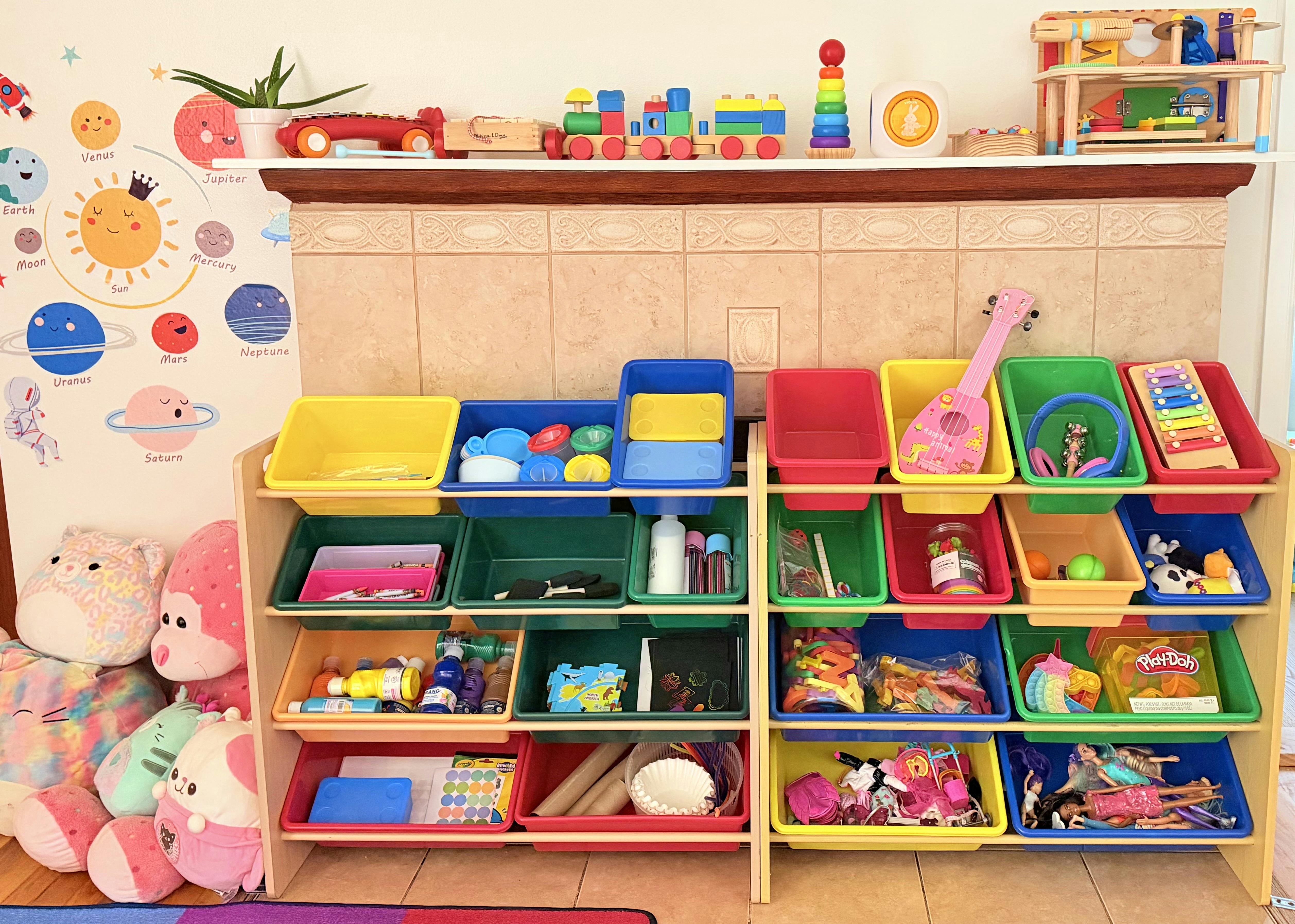 Children's room with toy storage shelves, stuffed animals, and a solar system chart