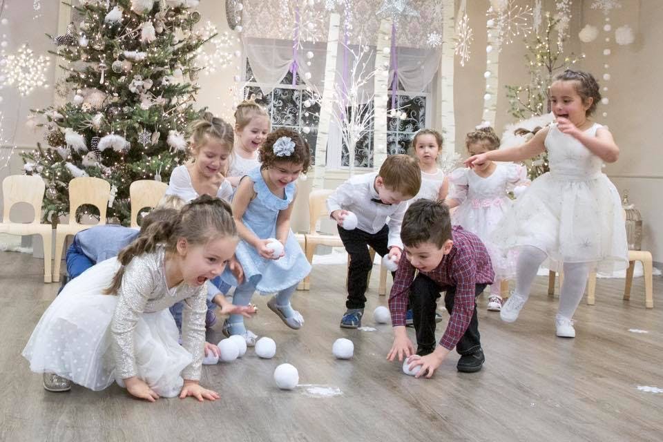 Children playing with white balls on the floor