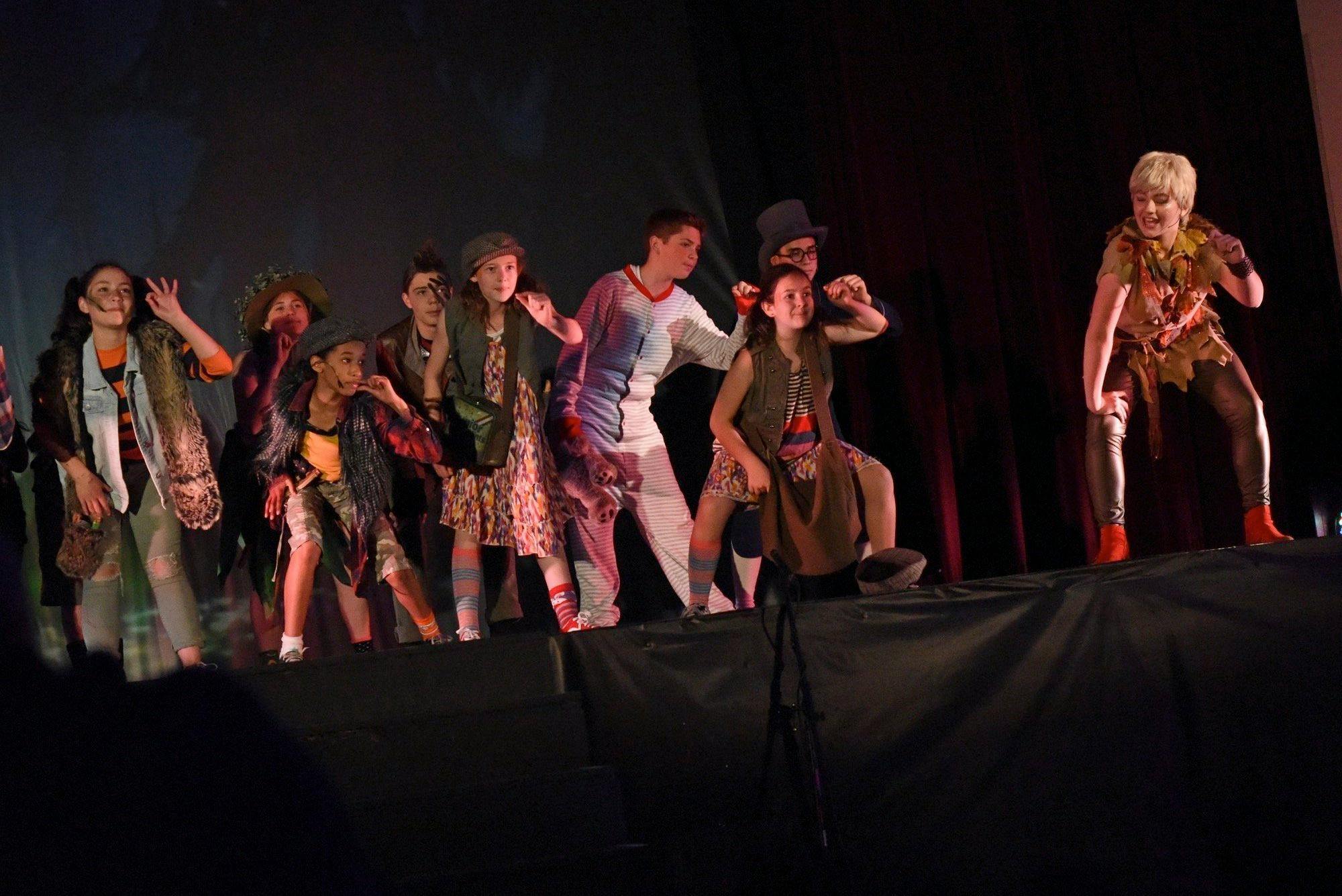Children and teens in costume on a stage