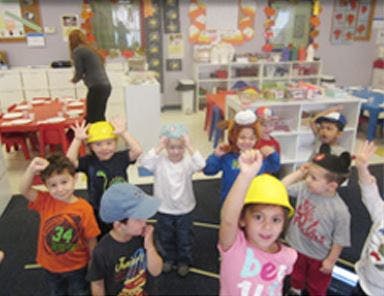 Children wearing hats in a classroom