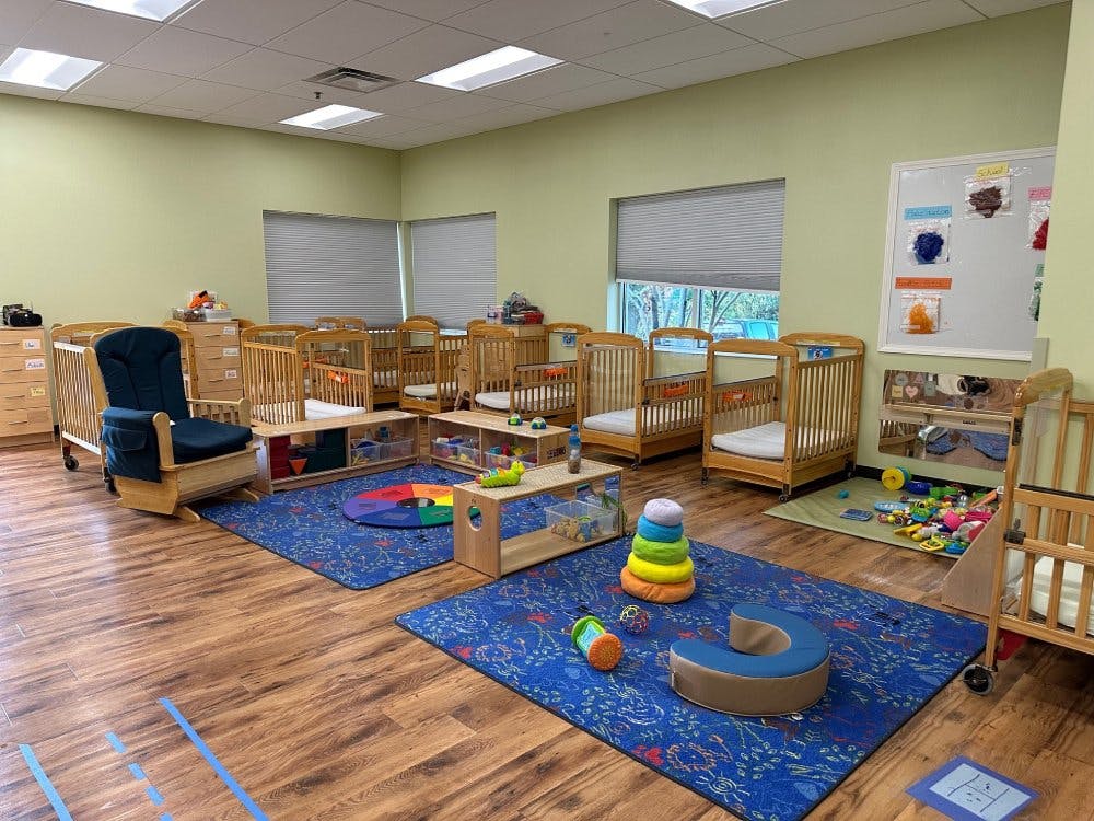 Cribs and small play areas in a daycare nursery