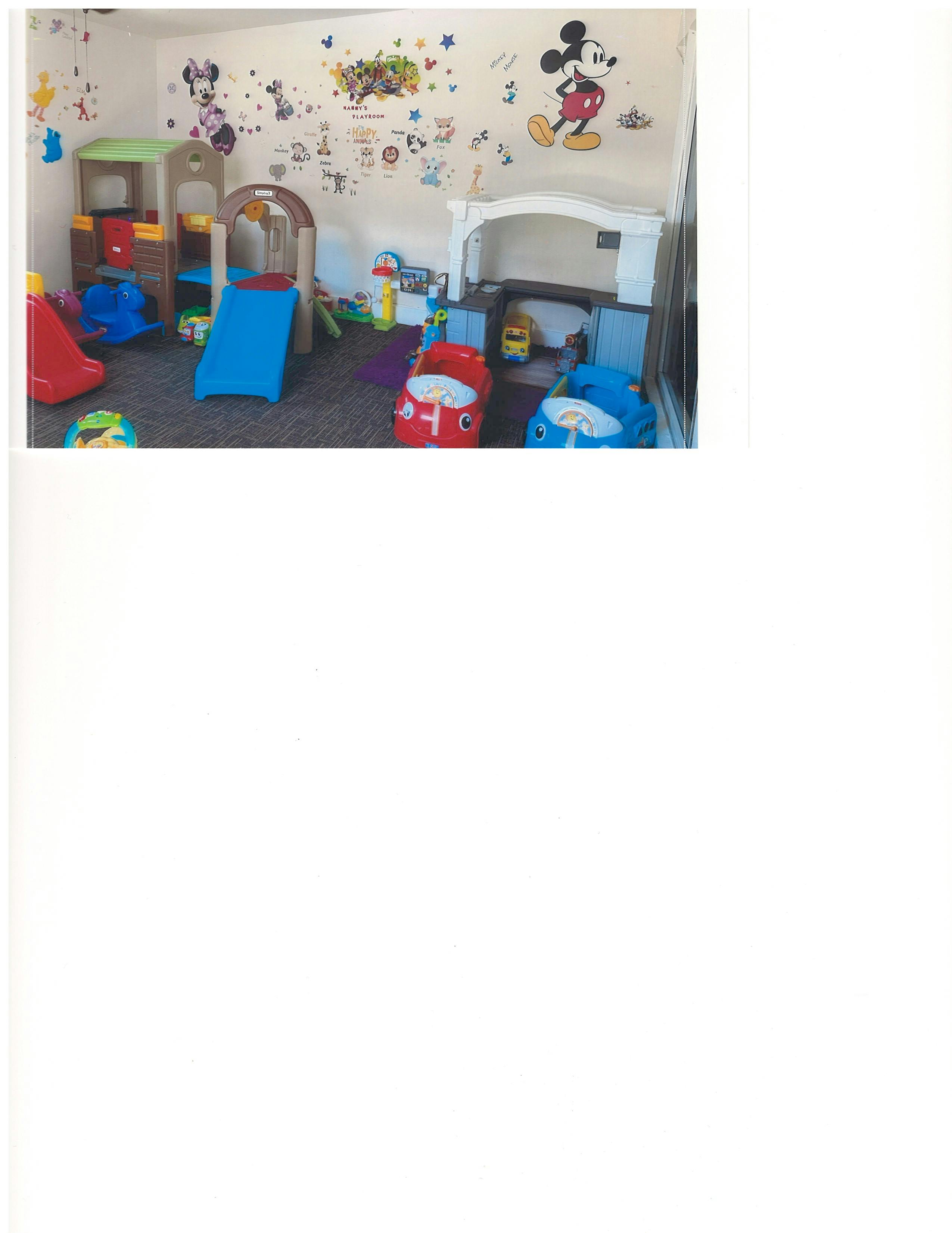 Playroom with slides, play structures, and car-shaped seats