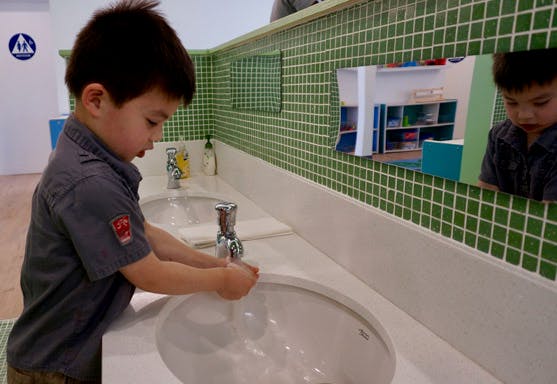 Child washing hands at a sink
