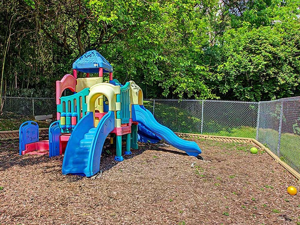 Colorful plastic playground set on woodchip ground