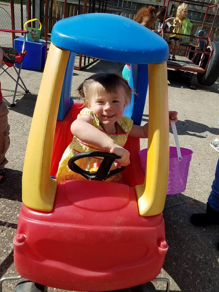 Child in a toy car