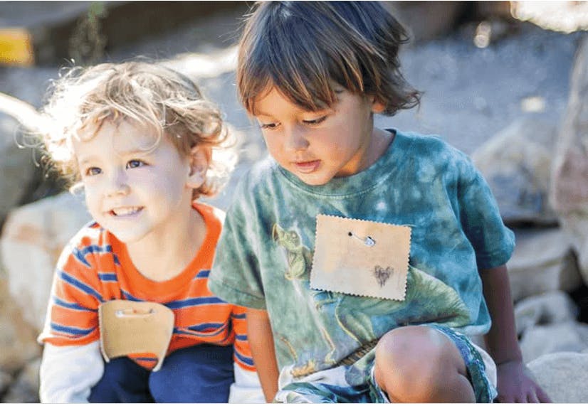 Two children sitting together outdoors