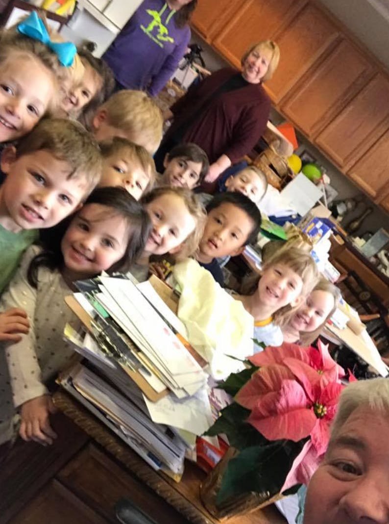 Group of children and adults smiling at the camera