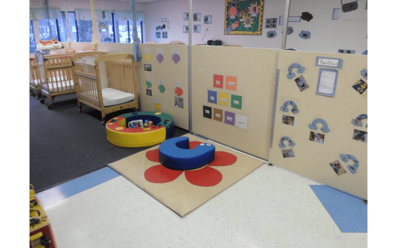 Cribs and play area in a daycare setting