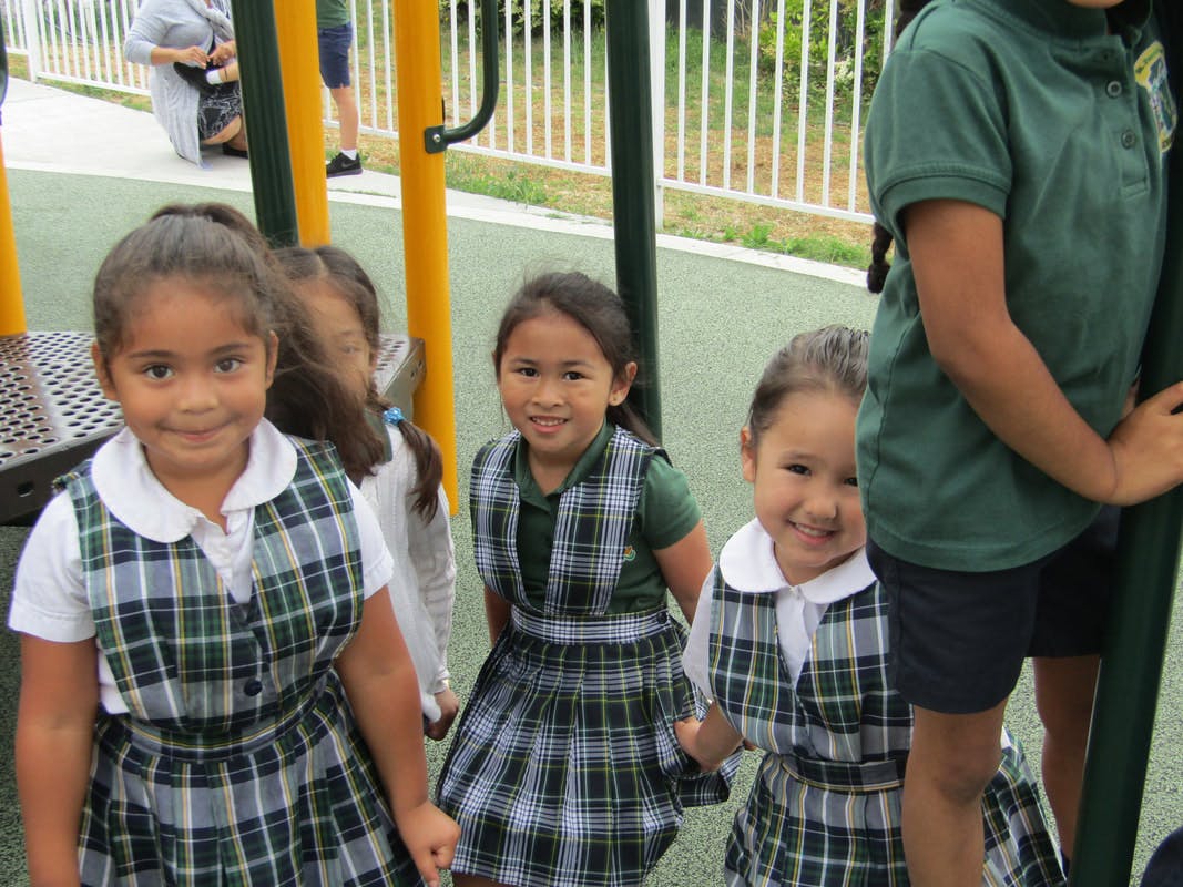 Children in plaid uniforms on a playground