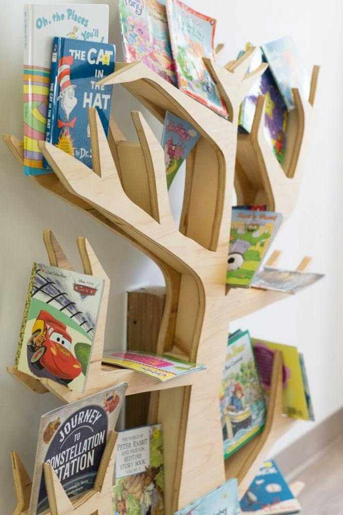 Tree-shaped bookshelf holding children's books