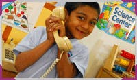 Child holding a telephone receiver to their ear