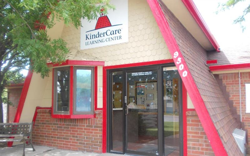 KinderCare Learning Center sign on a building with a red roof