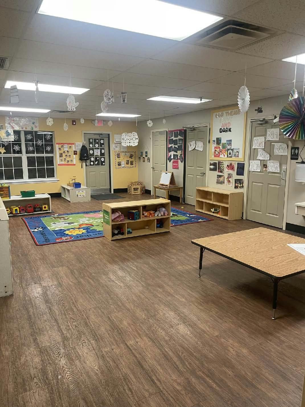 Classroom decorated with paper cutouts and two small tables