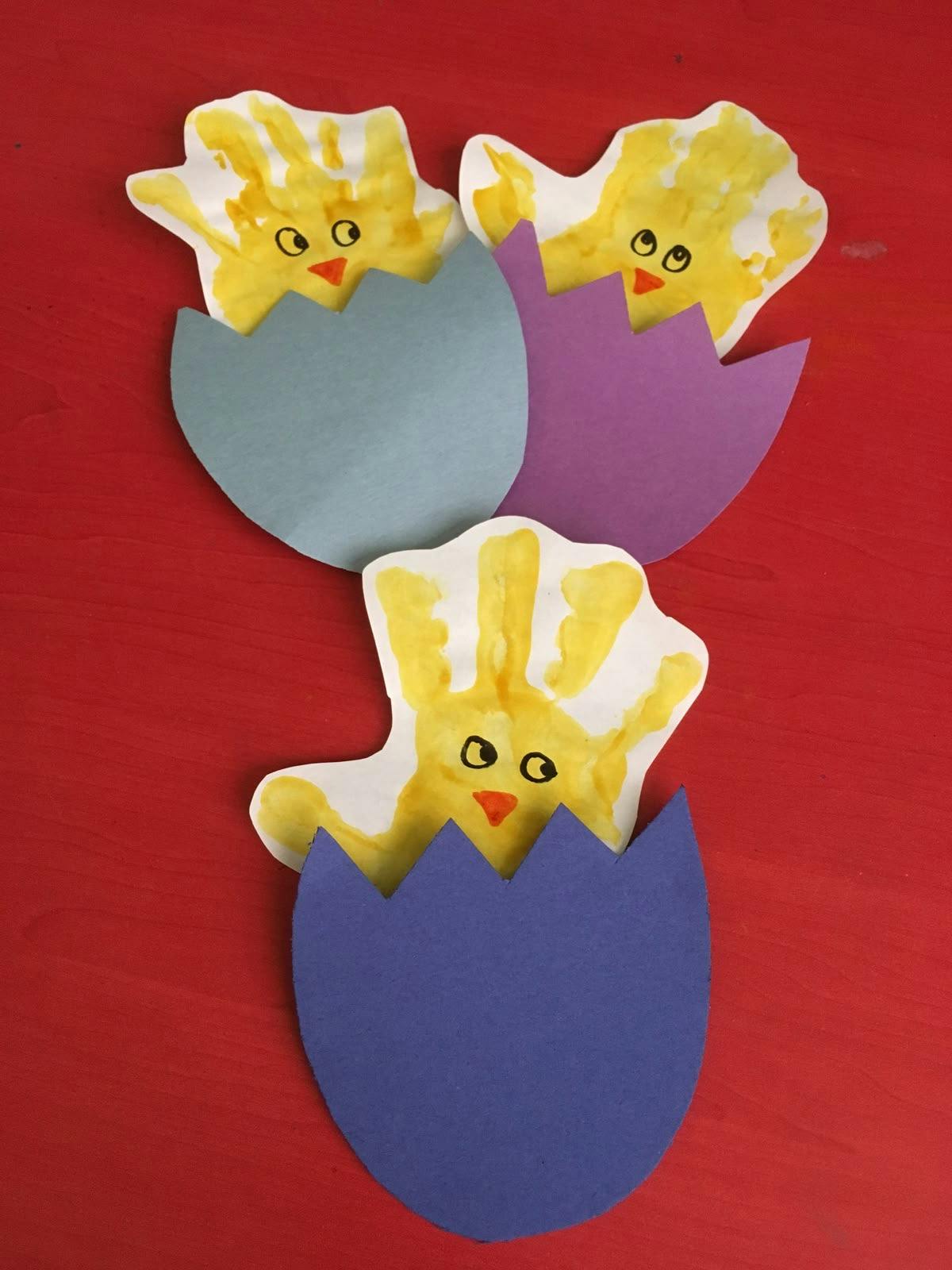 Three yellow chick crafts in colorful paper eggshells
