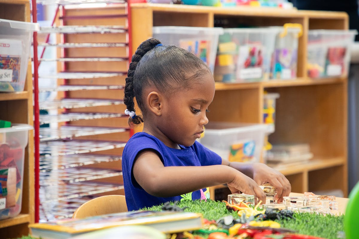 Child playing with toys in a classroom
