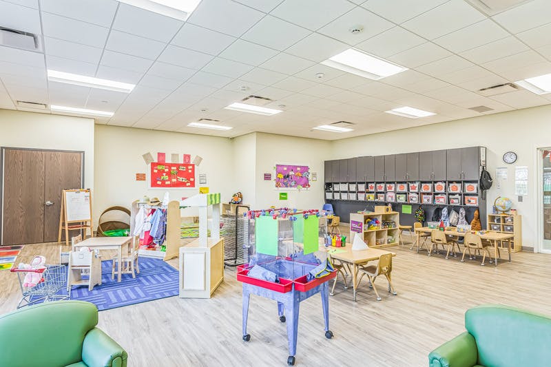 A colorful classroom with various play and learning stations