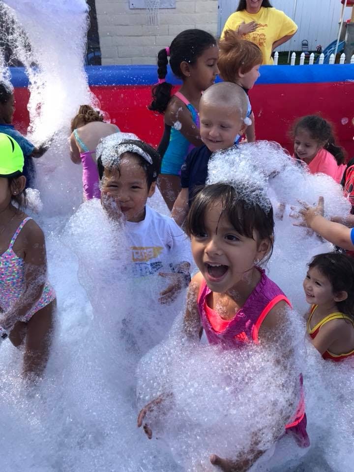 Children playing in a large pile of foam