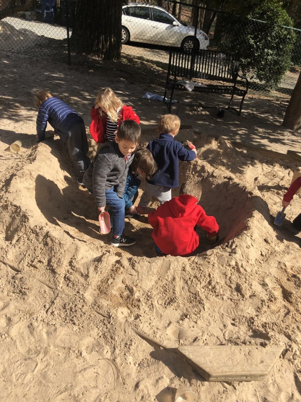 Children playing in a large sandpit