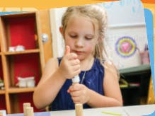 Child stacking wooden blocks