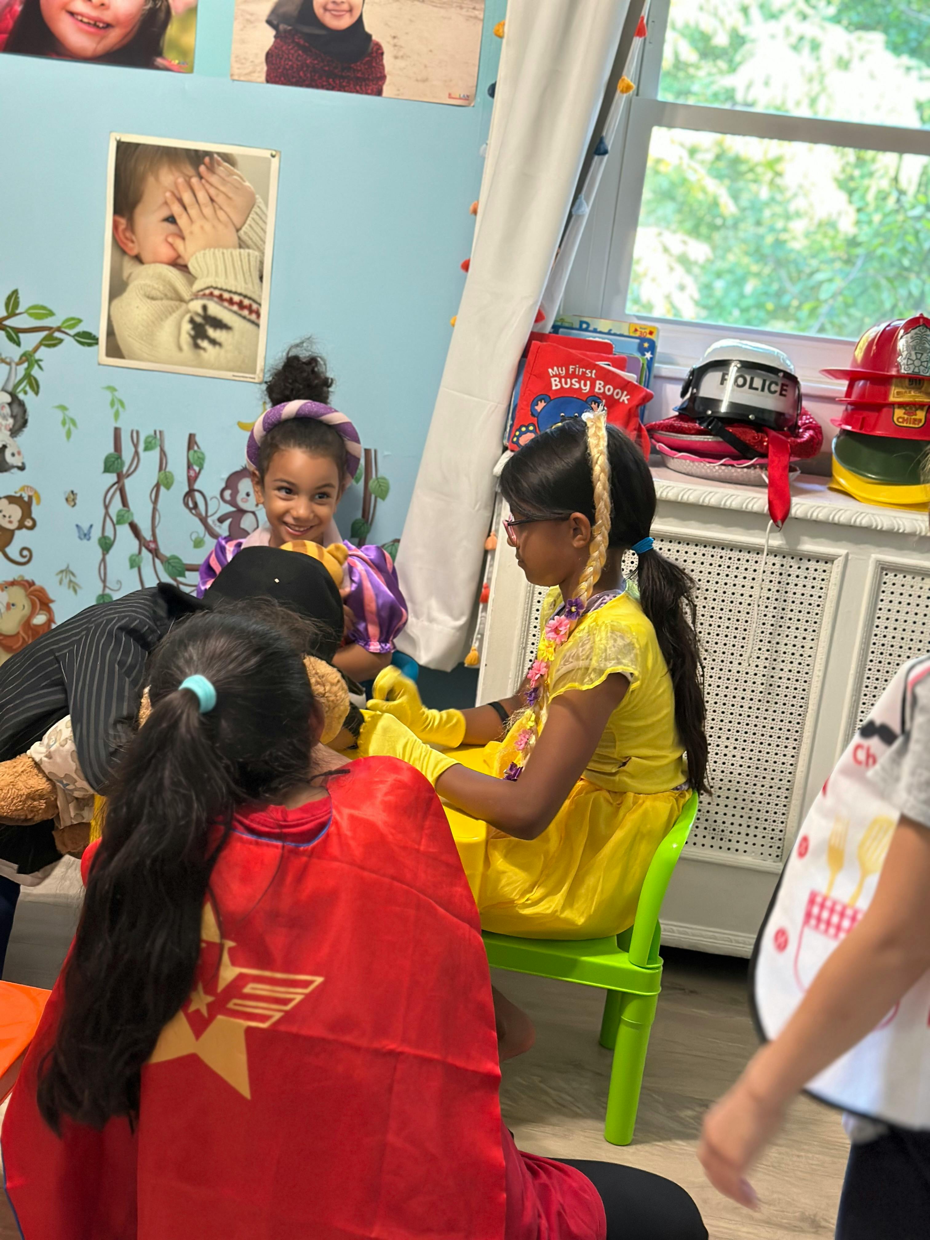 Children in costumes playing in a classroom