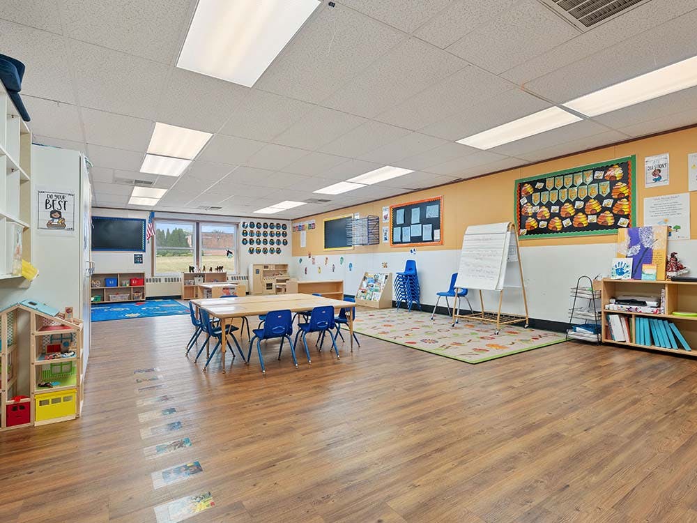 Classroom with small tables, chairs, and learning materials