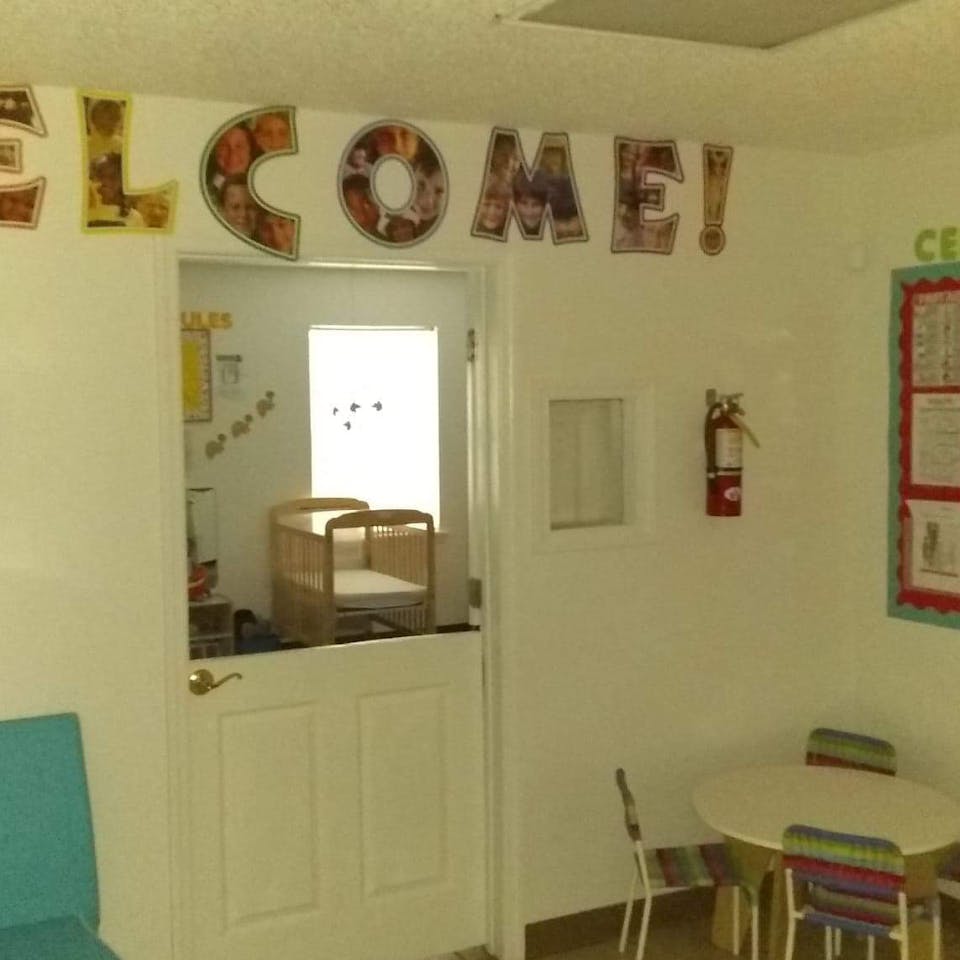 Welcome sign above a half-door leading to a room with a crib