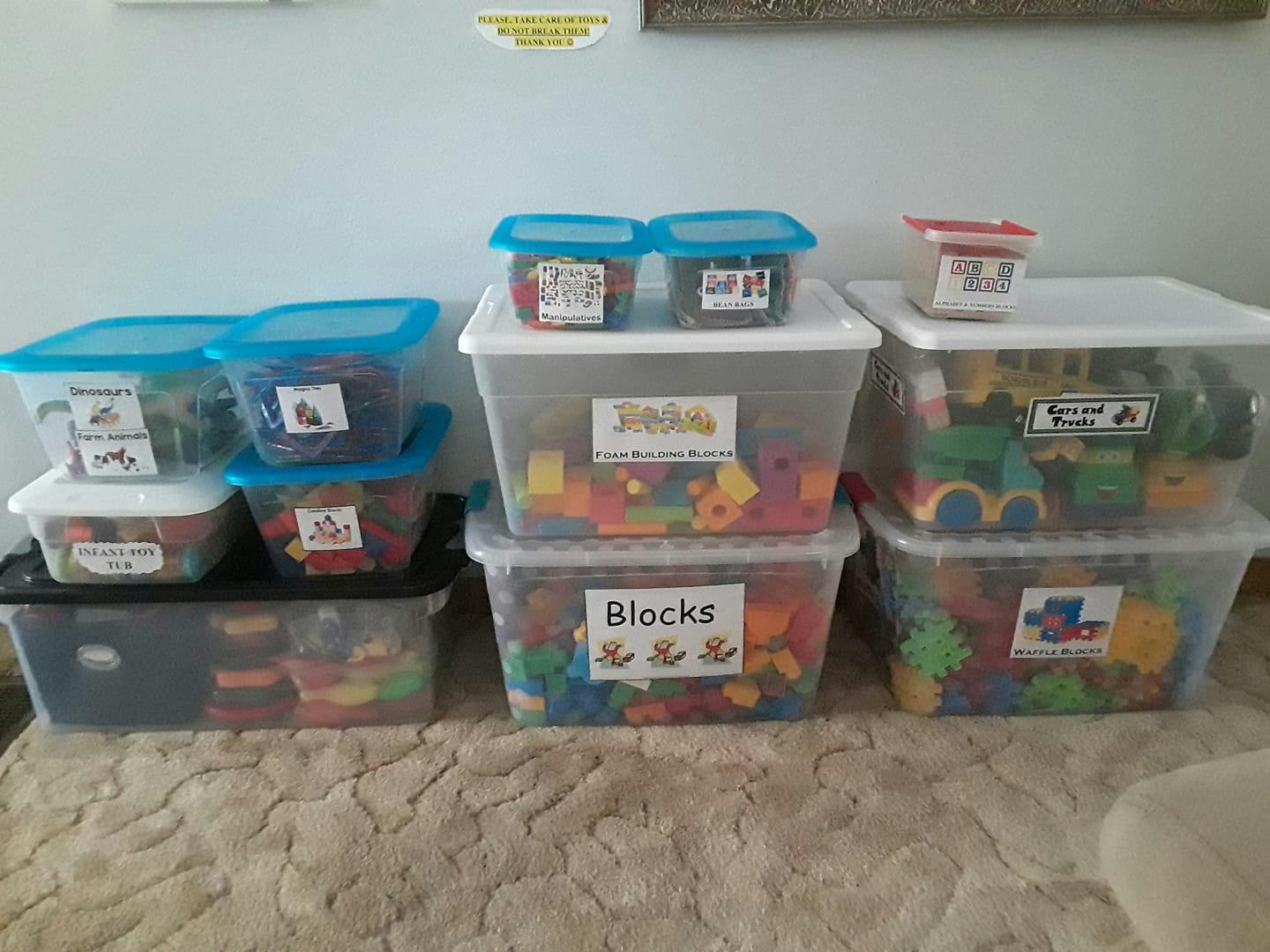 Clear plastic containers filled with colorful toys, some labeled "Blocks"
