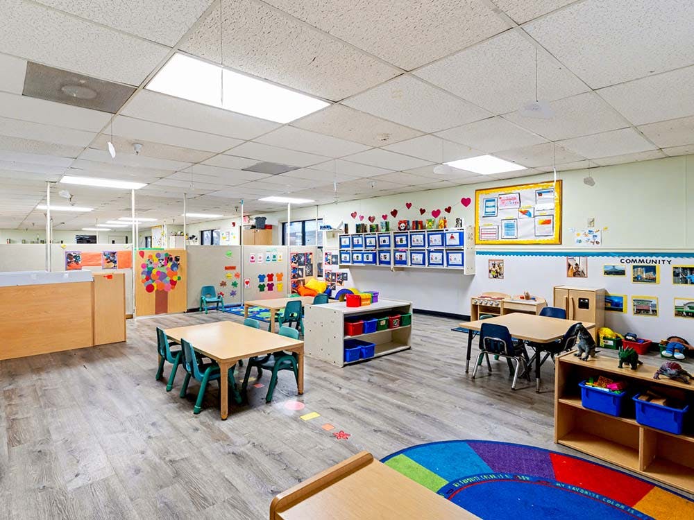 Empty classroom with small tables and chairs