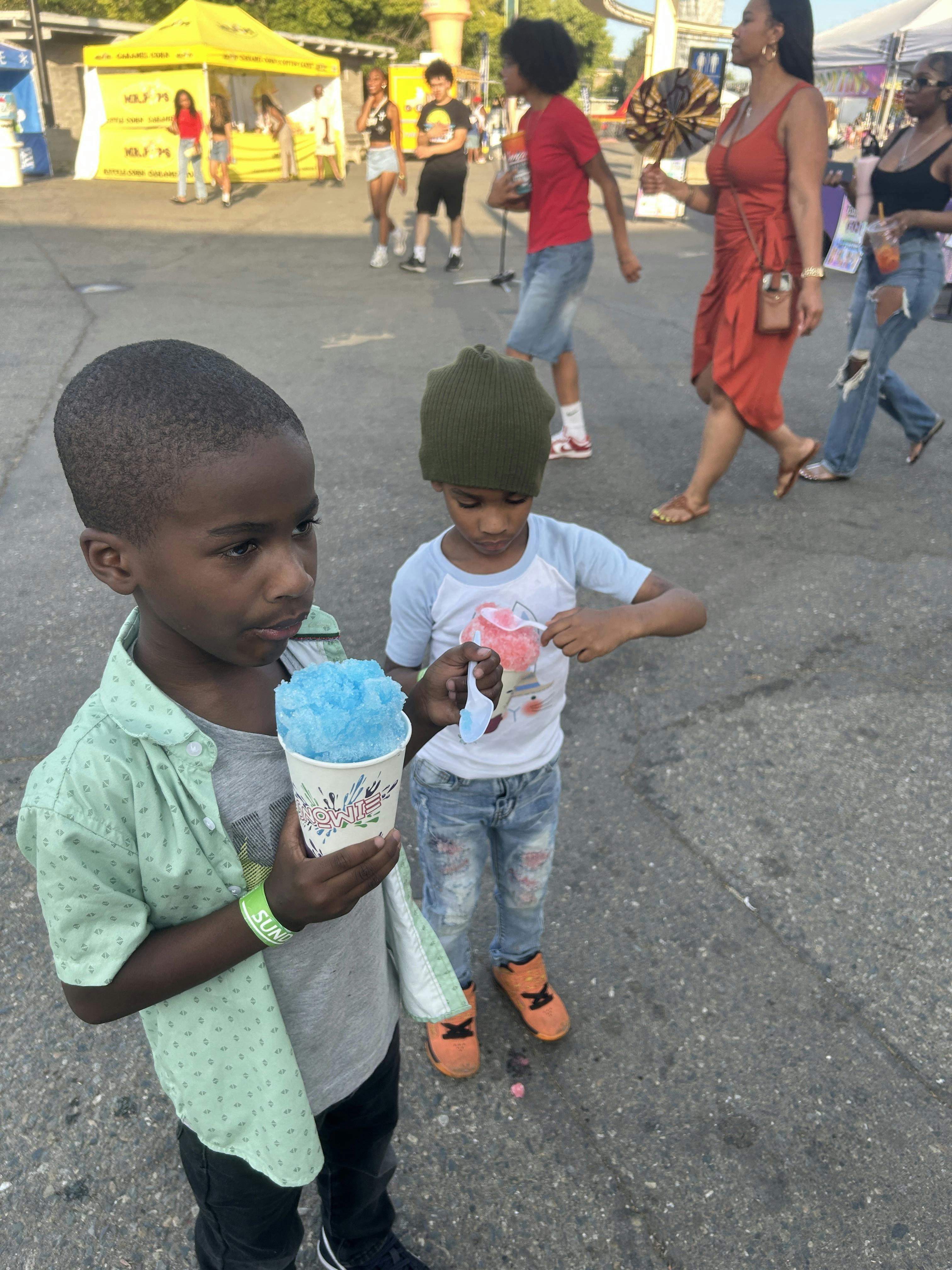 Two children holding cotton candy