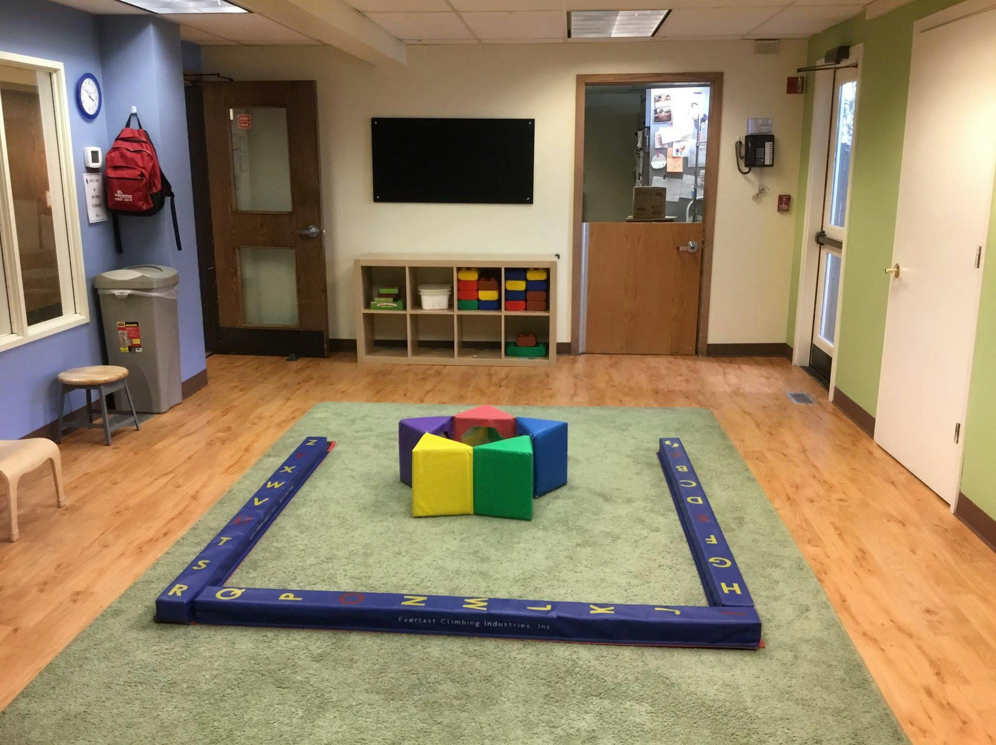 Playroom with colorful blocks on a green rug