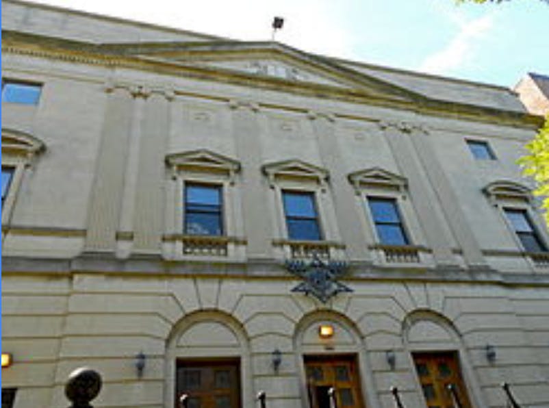 Exterior of a building with arched doorways and rectangular windows