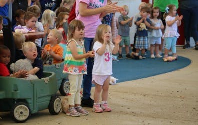 Group of children and adults clapping