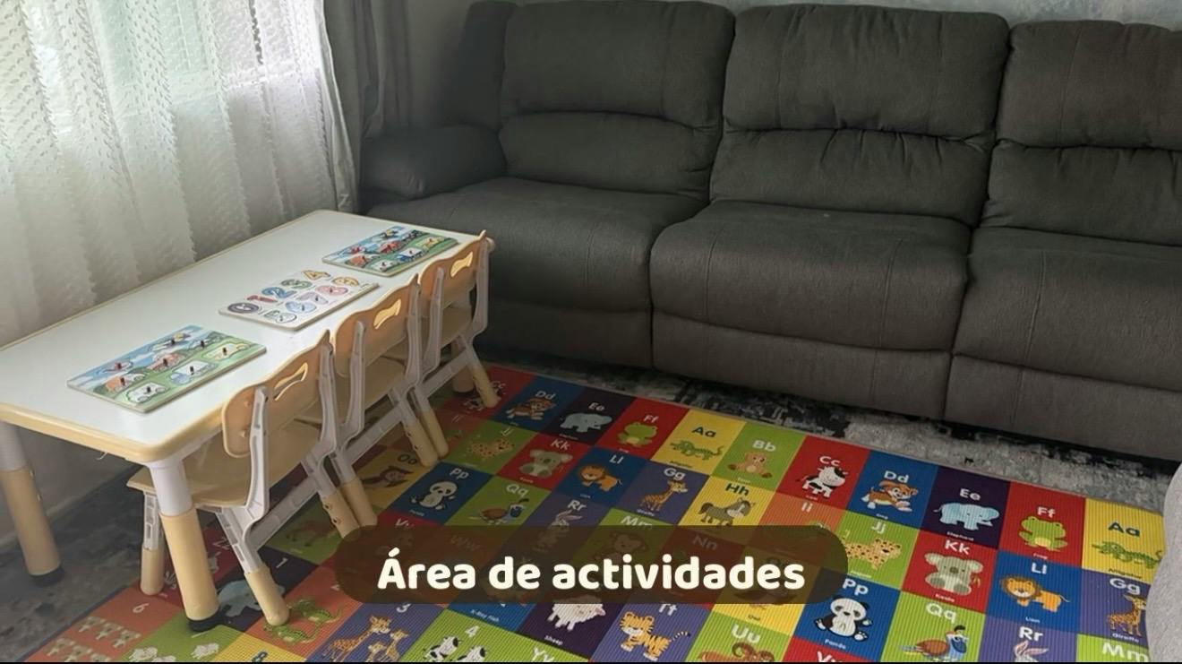 Small table and chairs with educational puzzles on an alphabet floor mat