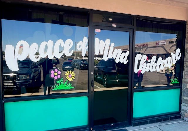 Storefront window with "Peace of Mind Childcare" text