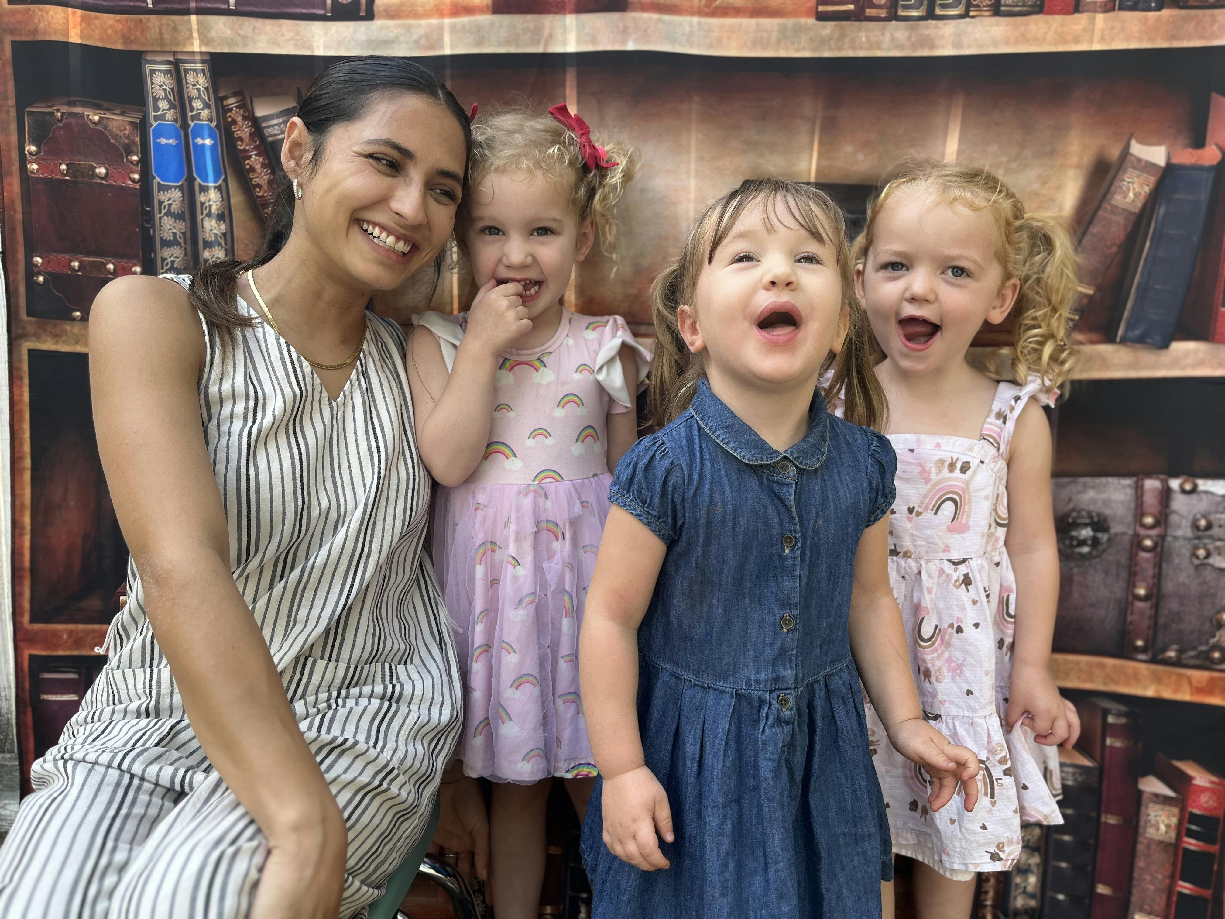 Person and three children smiling and laughing