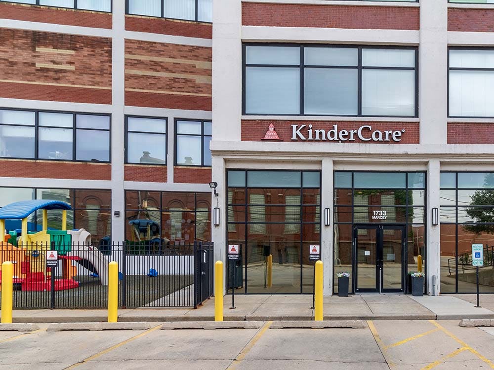 A KinderCare building with a playground outside
