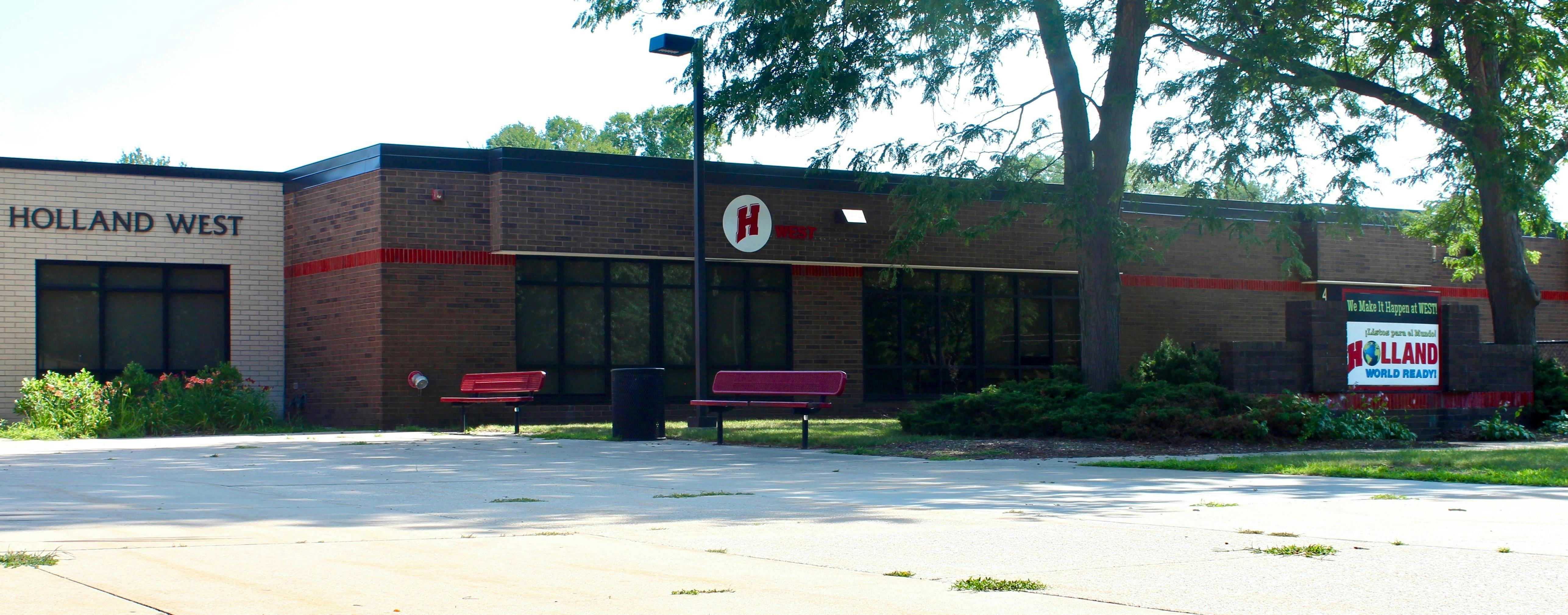 Exterior of a brick building with "HOLLAND WEST" on the facade