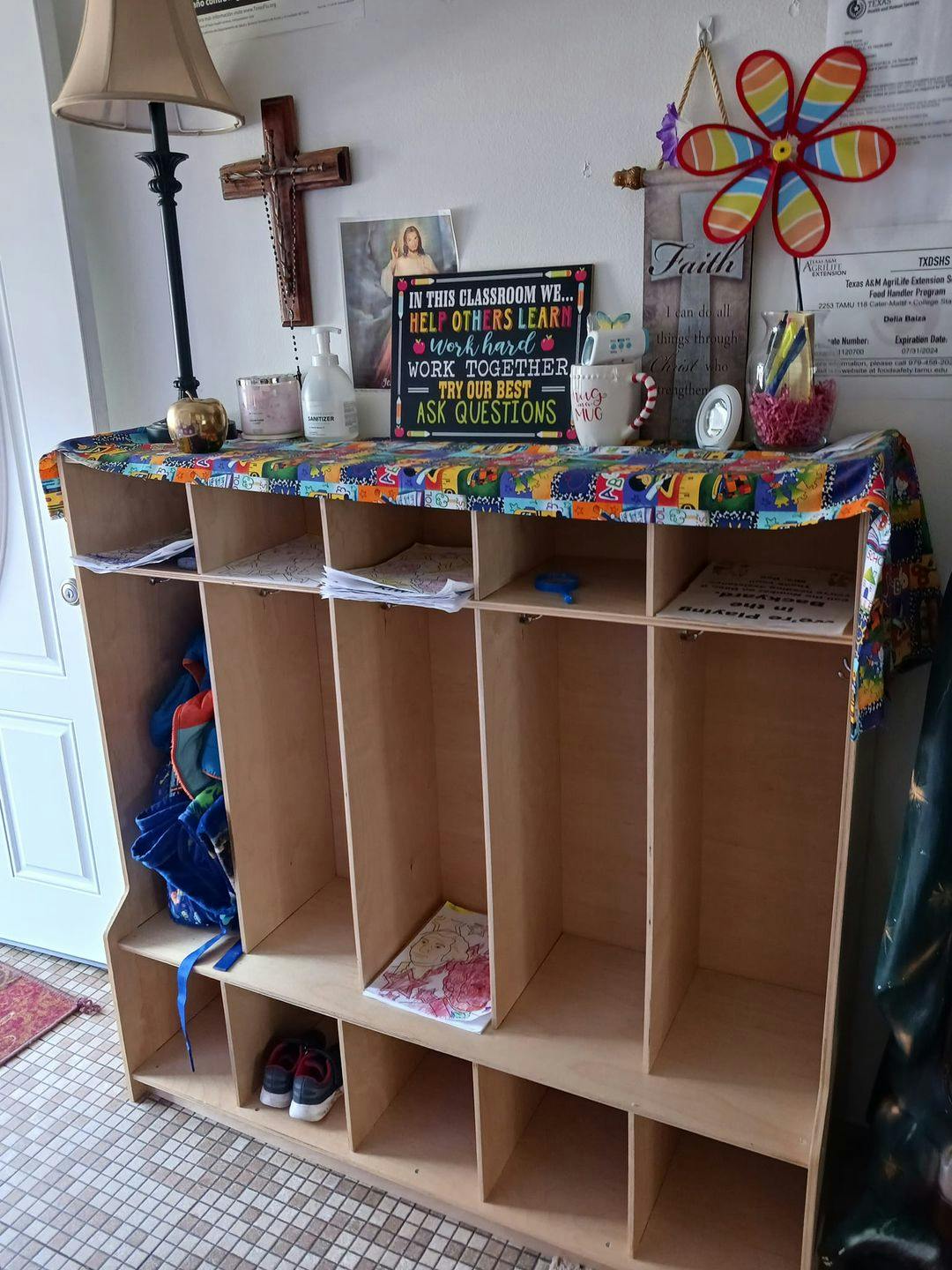 Wooden cubby storage unit with school supplies and decor in a classroom